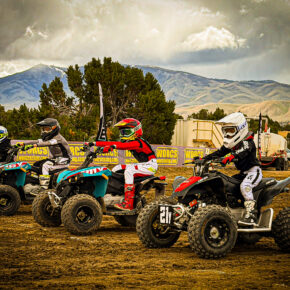 Four kids lining up to race on atvs