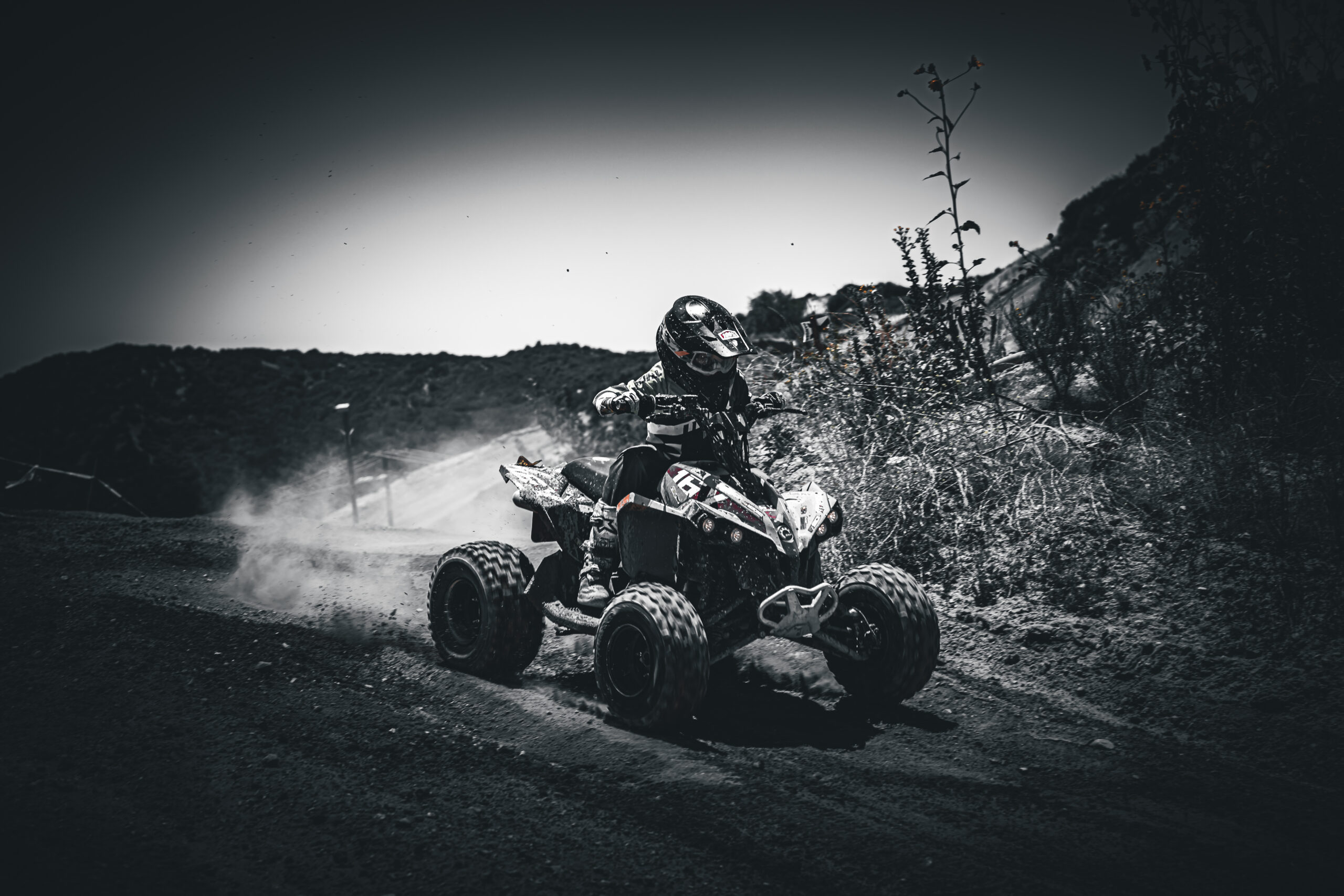 NXgen racer coming around a left turn in black and white